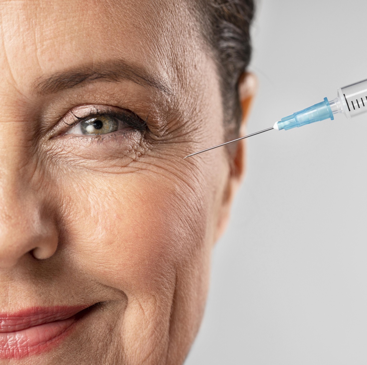 smiley-elder-woman-using-injection-for-her-eye-wrinkles